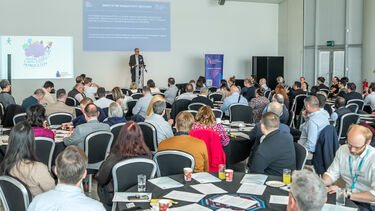 Jason Heyes addresses a roomful of people