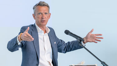 Andy Haldane speaking in front of a microphone