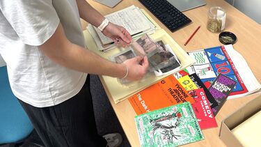 Aaron reviewing items in the Special Collections archive