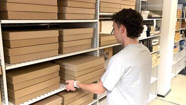 Aaron sorts boxes in the Special Collections archive