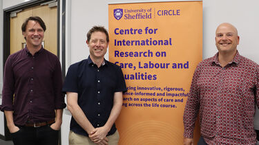 Professor Nathan Hughes, Jon Glasby and Liam Foster posing in front of a CIRCLE banner