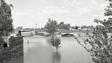 Houses and trees partially submerged under flood water