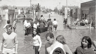 People wading through flooded streets