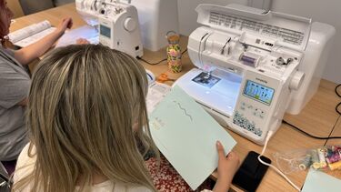 A student using a sewing machine for digital stitchcraft