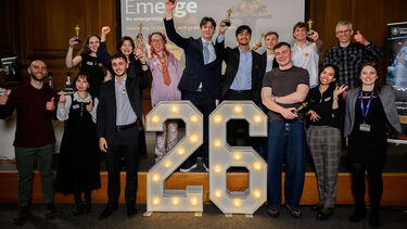 Group of students cheering on stage celebrating Emerge Awards Showcase 26