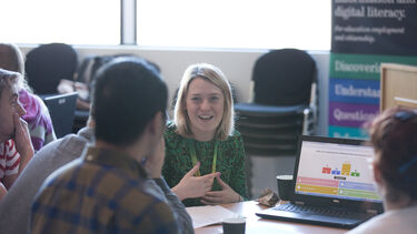Tutor and students in a research skills workshop