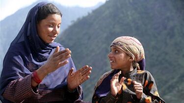 Maryam Bano (L) and nine-year old Aisha, both Deaf and mute, use sign language to communicate at Dadhkai Village in Doda district, 260 km north of Jammu, June 18, 2009, by M. Gupta, 2009, Reuters. 
