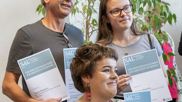 Students showing certificates with academic 