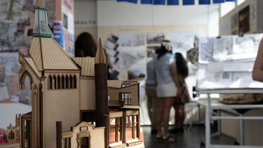 Visitors looking at Architecture posters and models 