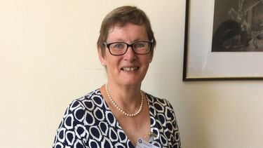 Profile of Carol Morris holding an award