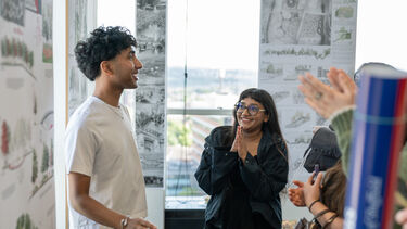Landscape student shows family their work and celebrates 