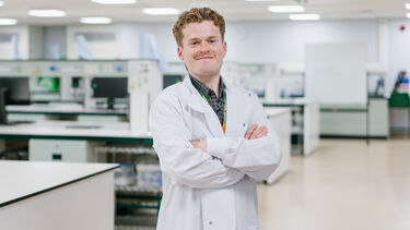 Declan Wales stood in a Biosciences Laboratory 