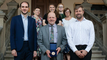 Photo from the award ceremony showing Prof. Bermel holding his medal