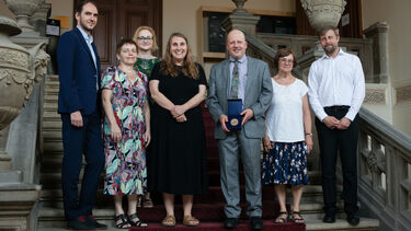 Photo from the award ceremony showing Prof. Bermel holding his medal
