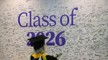 Management student signing graduation wall class of 2026
