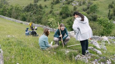 Three students conducting field work in the Peak District
