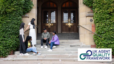 A group of five students sit on the steps of a grand university building and talk with one another. The UK Agent Quality Framework logo is placed in the bottom right of the image.