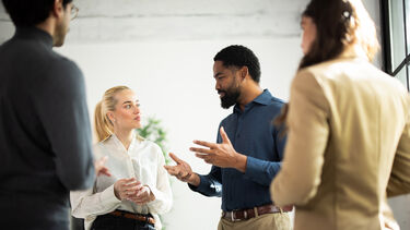 A group of four people talking.