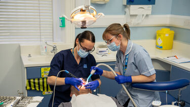 Dental student working on a patient