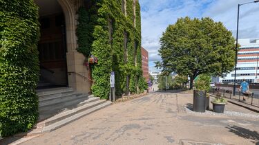 View of the broken and uneven driveway surface at the main entrance to Firth Court