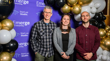 Three members of enterprise staff smiling at camera 