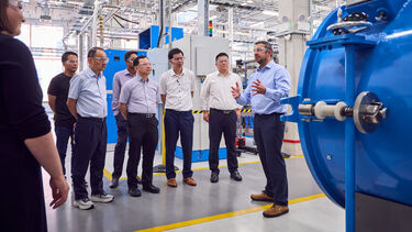 People visiting a lab with googles on 