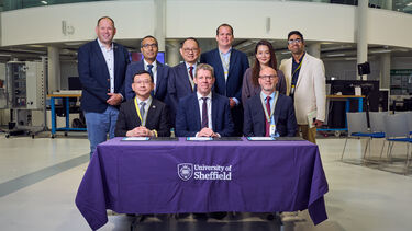 Group of dignitaries behind a table 