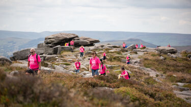 Walkers trek across Stanage Edge in the Peak District