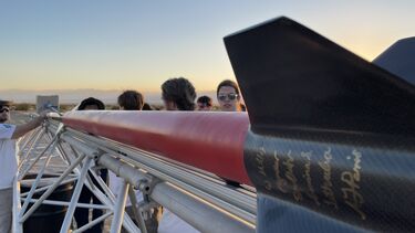 Students with the Karmen Delta rocket
