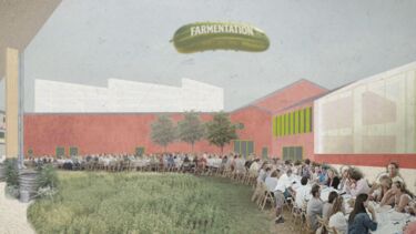 People sitting on a long table in the courtyard of some buildings with a green airship above