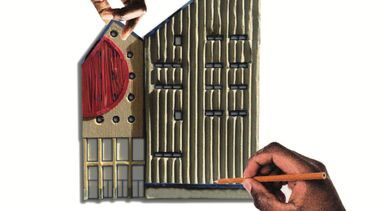 Two hands completing a model of the side of a building with windows