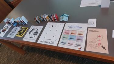A range of zines on a table, which attendees could draw inspiration from. 
