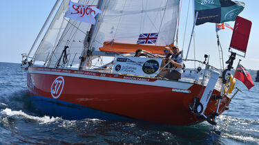 A red sailboat on the ocean 