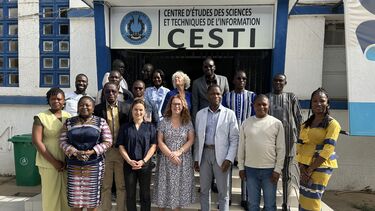 A group of people standing in front of the CESTI building in Senegal