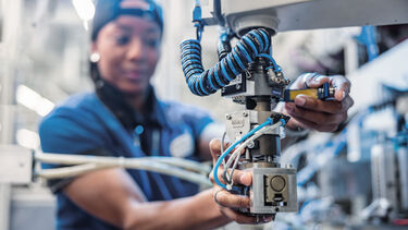 Siemens worker operating machine arm