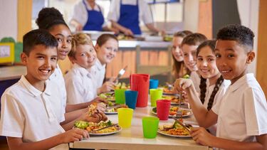 Children all together enjoying a school lunch
