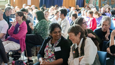 People in audience talking in pairs