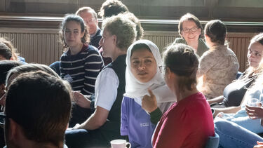 People in audience talking in pairs