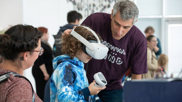 A child trying a VR experience at Festival of the Mind