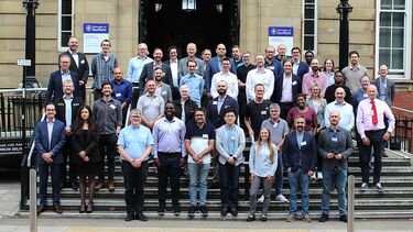 40 delegates standing in front of the Mappin building
