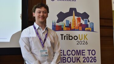 Jaden standing in front of a banner with TriboUK 2026 written on it