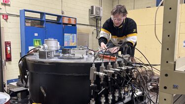 Engineering student working on a large piece of equipment