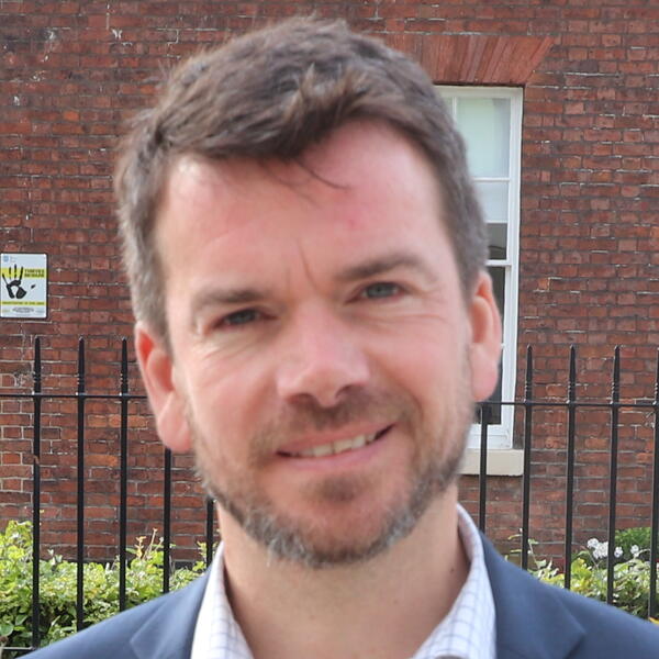 Profile picture of Chris Bennett stood outside HRI building