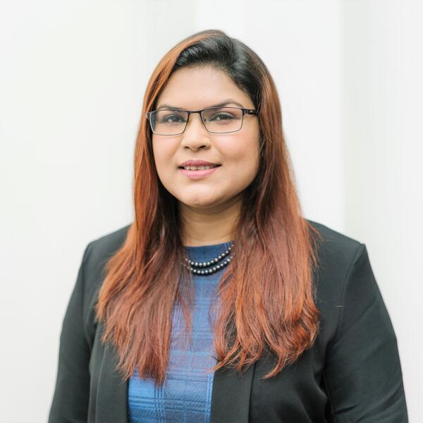 Profile picture of Sharmin Rahman wearing a blue top and black blazer.