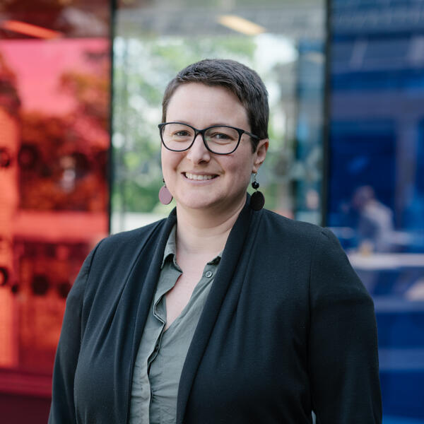 Profile picture of Katy Fox-Hodess wearing a green shirt and black jacket.