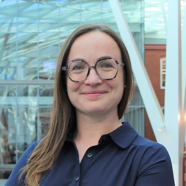 Profile picture of Woman in dark blue shirt with glasses