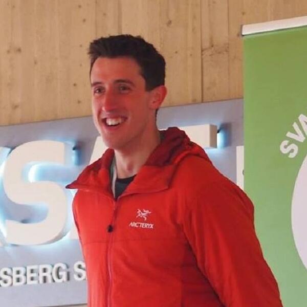 Profile picture of Benjamin Davison in a red jacket, smiling