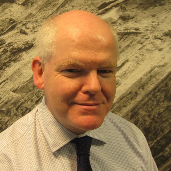 Profile picture of A man in a checked shirt with dark tie