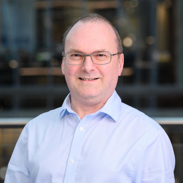 Profile picture of Portrait of academic with blue shirt, with glasses, smiling