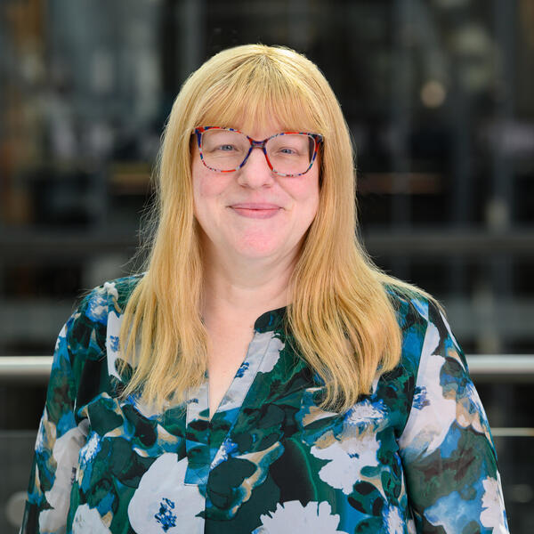 Profile picture of Portrait of smiling academic with colourful shirt and colourful glasses